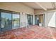 Tile patio with seating area and sliding glass doors with views of lush landscape at 9125 E Purdue Ave # 214, Scottsdale, AZ 85258