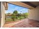 Outdoor patio with tile flooring and views of the green landscaping and tennis courts at 9125 E Purdue Ave # 214, Scottsdale, AZ 85258