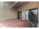 Relaxing tile patio with seating area and sliding glass doors overlooking outdoor view at 9125 E Purdue Ave # 214, Scottsdale, AZ 85258