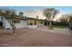 Back exterior view with manicured landscaping, a fountain, and a covered patio area at 918 W Carmen St, Tempe, AZ 85283