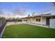 Expansive backyard featuring artificial turf, a fountain, and a covered patio, perfect for outdoor living at 918 W Carmen St, Tempe, AZ 85283