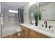 Stylish bathroom featuring a double vanity, modern fixtures, and a shower with marble-style tile surround at 918 W Carmen St, Tempe, AZ 85283