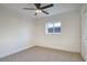 A bedroom with neutral carpet, a ceiling fan, and one window at 918 W Carmen St, Tempe, AZ 85283