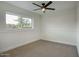 Bright bedroom featuring neutral carpet, a modern ceiling fan, and a window providing natural light at 918 W Carmen St, Tempe, AZ 85283