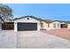 Single-story home showcasing a tidy lawn, painted brick, and two car garage at 918 W Carmen St, Tempe, AZ 85283