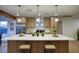 Kitchen island illuminated by pendant lighting and equipped with counter seating at 918 W Carmen St, Tempe, AZ 85283