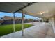 Covered patio overlooking a manicured backyard with artificial turf and a charming fountain at 918 W Carmen St, Tempe, AZ 85283