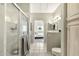 Clean bathroom showcasing a glass shower, tile floors, and a view into the main bedroom at 9455 E Raintree Dr # 2020, Scottsdale, AZ 85260