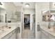 Bright bathroom with dual vanity sinks, modern lighting, and walk-in shower at 9455 E Raintree Dr # 2020, Scottsdale, AZ 85260