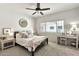 Comfortable bedroom with a ceiling fan and light color scheme plus sitting area next to a sunny window at 9455 E Raintree Dr # 2020, Scottsdale, AZ 85260