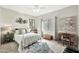 Bright bedroom with a decorative rug, a ceiling fan, and neutral-colored walls at 9455 E Raintree Dr # 2020, Scottsdale, AZ 85260