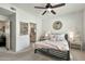 Serene bedroom with a view into the bathroom, a ceiling fan, and neutral-colored walls at 9455 E Raintree Dr # 2020, Scottsdale, AZ 85260