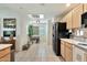 Bright, airy kitchen featuring white tile floors, stainless steel appliances, and skylight at 9455 E Raintree Dr # 2020, Scottsdale, AZ 85260