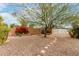 Charming backyard featuring mature trees and a vibrant flower garden at 10125 W Pine Springs Dr, Sun City, AZ 85373