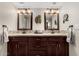 Bathroom featuring dual sinks, wood cabinets and mosaic tile backsplash at 10125 W Pine Springs Dr, Sun City, AZ 85373