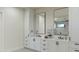 Bright bathroom featuring double vanities, white cabinetry, and modern fixtures at 10242 N 58Th St, Paradise Valley, AZ 85253