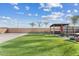 Expansive backyard features artificial turf, a hot tub under pergola, and desert landscaping at 10713 E Tesla Ave, Mesa, AZ 85212