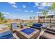 Backyard with an outdoor seating area with a fire pit, artificial grass, and mature trees at 10713 E Tesla Ave, Mesa, AZ 85212