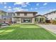 Large backyard featuring artificial turf, an outdoor living area, and desert landscaping at 10713 E Tesla Ave, Mesa, AZ 85212