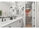 Bright bathroom features double sinks, white cabinets, and stylish fixtures, blending modern design with practicality at 10713 E Tesla Ave, Mesa, AZ 85212