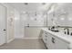 Stylish bathroom features a seamless glass shower, double vanity, and modern finishes at 10713 E Tesla Ave, Mesa, AZ 85212