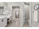 Spacious bathroom featuring patterned tile floors, a dual vanity and water closet at 10713 E Tesla Ave, Mesa, AZ 85212