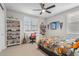 A teenager's bedroom featuring a basketball themed comforter set and various wall decorations at 10713 E Tesla Ave, Mesa, AZ 85212