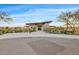 The Club building exterior featuring stone accents, desert landscaping, and a modern design at 10713 E Tesla Ave, Mesa, AZ 85212
