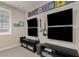 Spacious entertainment room features four large screen televisions and two guitars mounted on the wall at 10713 E Tesla Ave, Mesa, AZ 85212