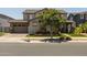 Charming two-story home with a tan exterior, manicured lawn, and inviting curb appeal at 10713 E Tesla Ave, Mesa, AZ 85212