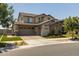 Inviting two-story home with a three-car garage, neutral exterior, and well-maintained landscaping at 10713 E Tesla Ave, Mesa, AZ 85212
