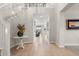 Grand foyer with a curved staircase, elegant decor, and wood-look tile flooring at 10713 E Tesla Ave, Mesa, AZ 85212
