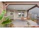 Charming front porch featuring a hanging swing and stone accents, creating a welcoming entrance at 10713 E Tesla Ave, Mesa, AZ 85212