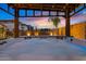 Outdoor hot tub under a wooden gazebo, lit by overhead string lights, with water feature in background at 10713 E Tesla Ave, Mesa, AZ 85212
