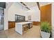 Modern kitchen features a large island, sleek countertops, and ample cabinet space at 10713 E Tesla Ave, Mesa, AZ 85212