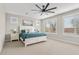 Serene main bedroom showcases plantation shutters, a ceiling fan and an ensuite bathroom at 10713 E Tesla Ave, Mesa, AZ 85212