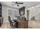 Dedicated office space features custom built-ins, a ceiling fan, and bright, natural light at 10713 E Tesla Ave, Mesa, AZ 85212