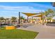 Outdoor seating area with tables, benches, and a fire pit, perfect for socializing and relaxing at 10713 E Tesla Ave, Mesa, AZ 85212