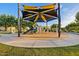 Community playground with slides, climbing equipment, and shade structures for a fun and safe play environment at 10713 E Tesla Ave, Mesa, AZ 85212