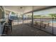A covered patio features a brick floor and view of the pool and adjacent trampoline at 10844 N 37Th St, Phoenix, AZ 85028