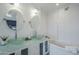 Modern bathroom with glass vessel sinks, sleek cabinets, and a soaking tub at 10844 N 37Th St, Phoenix, AZ 85028