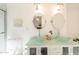 Bright bathroom featuring a modern double vanity with glass countertop and vessel sinks, complemented by stylish lighting fixtures at 10844 N 37Th St, Phoenix, AZ 85028