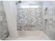 Walk-in shower with niche and grab bar with white and gray decorative tile at 10844 N 37Th St, Phoenix, AZ 85028