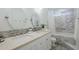 Well-lit bathroom with double sinks, decorative tile accents and soaking tub at 10844 N 37Th St, Phoenix, AZ 85028