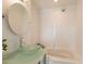 Bright bathroom featuring a modern vanity with glass countertop and vessel sink, plus a relaxing soaking tub at 10844 N 37Th St, Phoenix, AZ 85028