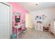 Cheerful bedroom with pink walls, white trim, desk area, and a decorative chandelier at 10844 N 37Th St, Phoenix, AZ 85028