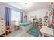 Bright bedroom featuring a single bed, wood floors, neutral walls, and a chandelier light fixture at 10844 N 37Th St, Phoenix, AZ 85028