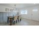 Inviting dining area with wood table, modern chandelier, and abundant natural light at 10844 N 37Th St, Phoenix, AZ 85028