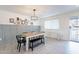 Dining room with modern lighting, paneled wall, and access to the front porch at 10844 N 37Th St, Phoenix, AZ 85028