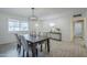 Inviting dining area with wood table, modern chandelier, and abundant natural light at 10844 N 37Th St, Phoenix, AZ 85028